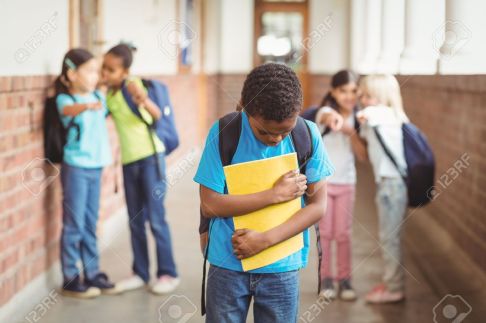 44851494-sad-pupil-being-bullied-by-classmates-at-corridor-in-school-Stock-Photo.jpg